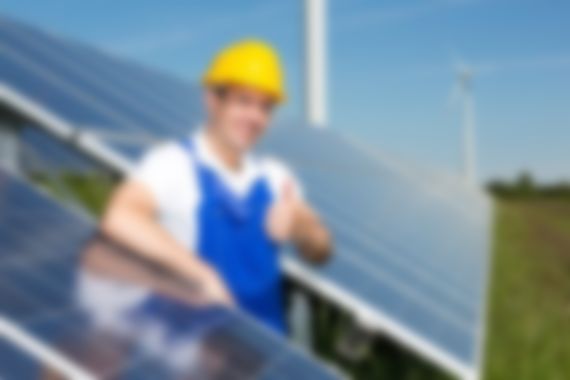 Photovoltaic engineer showing thumbs up at solar panel array